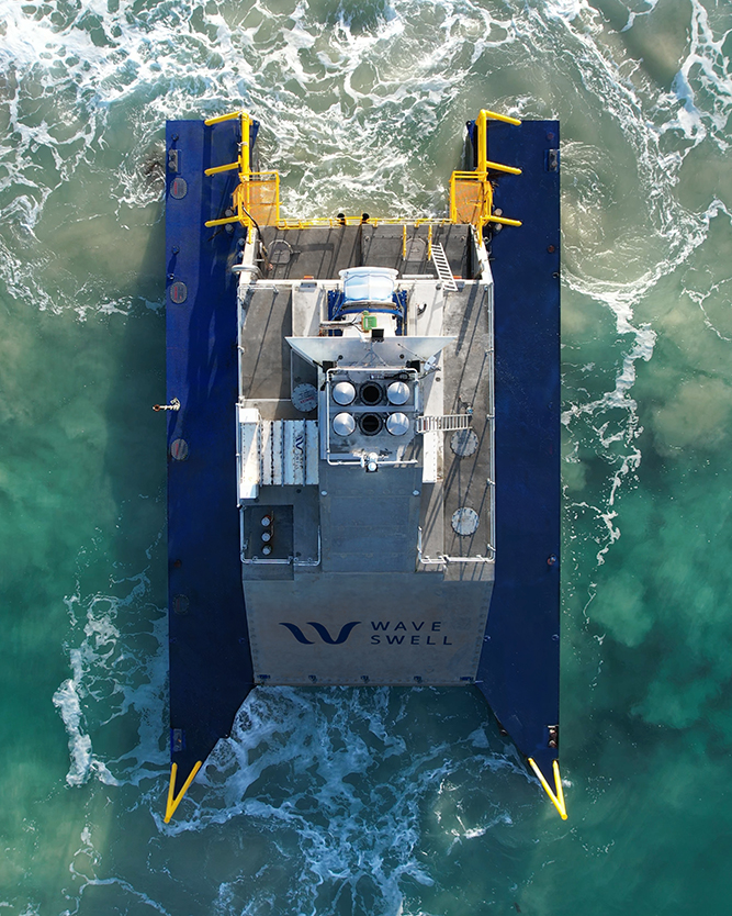 Aerial view of a wave energy converter, showcasing its structure and surrounding ocean waves.