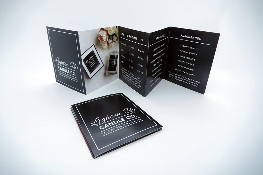 Brochure for Lighten Up Candle Co. showcasing candle sizes, prices, and fragrance options in a sleek black design.